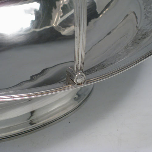 Antique Georgian sterling silver basket, having an oval body with an applied reeded edge, with a band of hand-engraved floral work and acorns, a hinged and reeded swing handle, all sitting on a collet foot. Made in London in 1800. The dimensions of this hand-made silver basket are height 27 cms (10.5 inches), length 35.5 cms (14 inches), width 23.5 cms (9.5 inches), and it weighs approx. 687g (22 troy ounces). Please note that although the hallmarks are rubbed the date letter E is evident. 