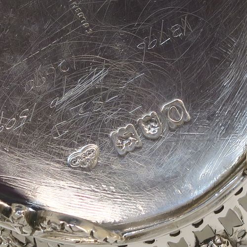 A very pretty Neoclassical style Antique Edwardian Sterling silver small table basket, having an oval body with hand-pierced decoration and hand-chased floral borders, all sitting on four cast lions-paw feet. This beautiful antique silver basket was made by Goldsmiths and Silversmiths of London in 1909. The dimensions of this fine antique silver basket are length 17 cms (6.75 inches), width 11 cms (4.3 inches), height 7 cms (2.75 inches), and it weighs approx. 227g (7.3 troy ounces).   