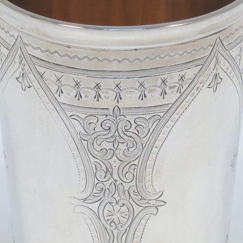 A very pretty and large Antique Victorian Sterling Silver beaker, having a round straight-sided body with tapering sides, with hand-engraved scroll and floral decoration  surrounding four vacant cartouches, a gold-gilt interior, and all sitting on a flat base. Made by William Evans of London in 1875. The dimensions of this fine hand-made antique silver beaker are height 12.5 cms (5 inches), diameter at top 8 cms (3 inches), and it weighs approx. 170g (5.5 troy ounces).   