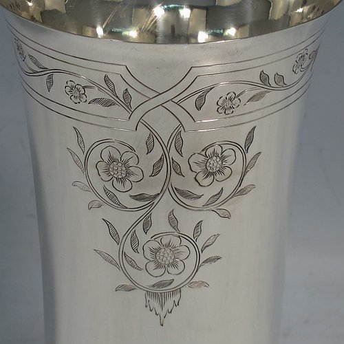 A Sterling Silver beaker in a 17th Century Charles I style, having a round straight-sided body with tapering sides, with hand-engraved floral work, all sitting on a hand-chased collet foot with an applied reeded band above. Made by Robert Frederick Fox of London in 1917. The dimensions of this fine hand-made silver beaker are height 13 cms (5 inches), diameter at top 8 cms (3 inches), and it weighs approx. 226g (7.3 troy ounces).   