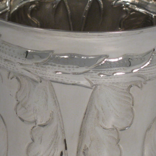 A very unusual and pretty Britannia Standard Silver Art Nouveau style beaker, having a round body with tapering sides, hand-chased floral decoration with tulips, and sitting on a collet foot. Made by S. J. Phillips of London in 1935, with extra Jubilee mark. The dimensions of this fine hand-made silver beaker are height 12 cms (4.75 inches), diameter at top 10 cms (4 inches), and it weighs approx. 244g (7.9 troy ounces).  