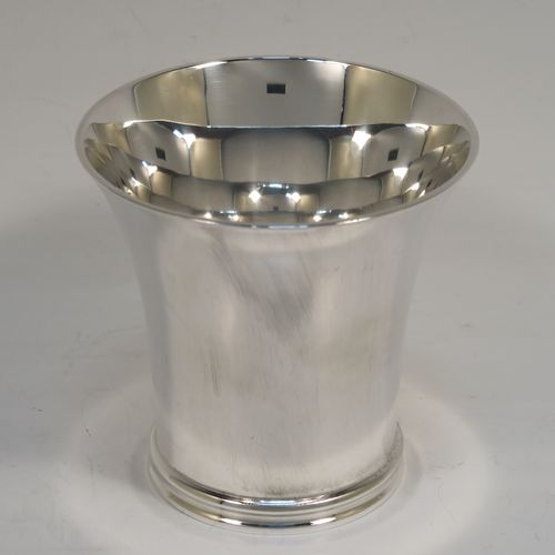 A heavy and very handsome Sterling Silver beaker cup, having a plain round body with tapering flared  sides, and sitting on a collet foot with an applied reeded border. This elegant silver beaker was made by Munsey and Co., of London in 1938. The dimensions of this fine hand-made silver beaker cup are height 9 cms (3.5 inches), diameter at top 9 cms (3.5 inches), and it weighs approx. 237g (7.6 troy ounces).   