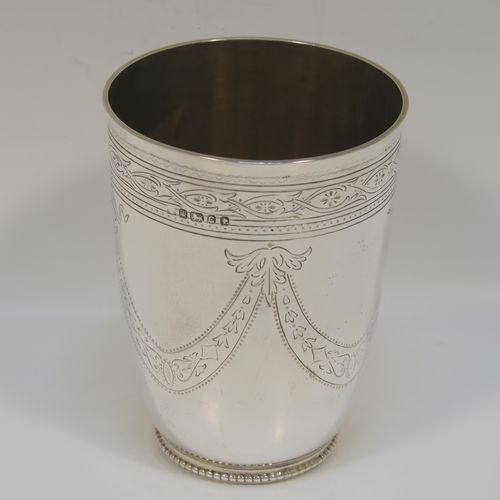 A beautiful Antique Victorian Sterling Silver beaker, having a round body with tapering sides, with hand-engraved floral and swag decoration, a gold-gilt interior, and all sitting on a collet foot with an applied bead-edged border. This very pretty silver beaker was made in Sheffield in 1874. The dimensions of this fine hand-made antique silver beaker are height 11 cms (4.25 inches), diameter at top 8 cms (3.25 inches), and it weighs approx. 170g (5.5 troy ounces).  