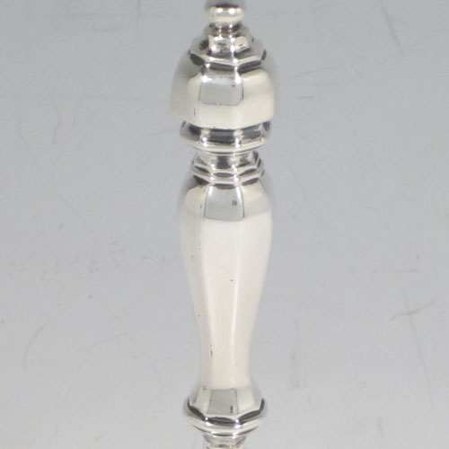 Antique Georgian sterling silver table bell having a round baluster body with hand-chased fruit and floral decoration, a cast octagonal handle, and an original silver clapper. Made by the Lias Brothers of London in 1828. The dimensions of this fine hand-made antique silver table bell are height 14 cms (5.5 inches), diameter at base 8 cms (3 inches), and it weighs approx. 225g (7.3 troy ounces).