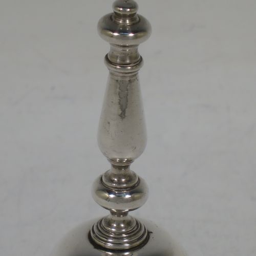 A very handsome Sterling Silver Georgian style table bell having a plain round body with applied reeded borders, a cast round baluster handle, and an original silver clapper. Made by C. J. Vander of London in 1972. The dimensions of this fine hand-made silver table bell are height 10 cms (4 inches), diameter at base 6 cms (2.3 inches), and it weighs approx. 158g (5 troy ounces).    