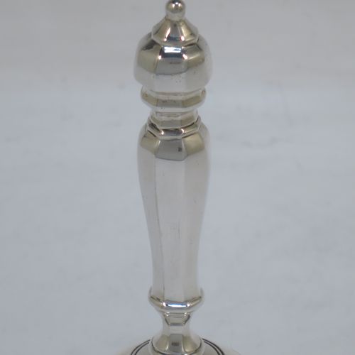 A very elegant Antique Victorian Sterling Silver table bell having a plain round body with an applied gadroon border, a cast octagonal baluster handle, and an original silver clapper. Made by George John Richards of London in 1855. The dimensions of this fine hand-made antique silver table bell are height 13 cms (5 inches), diameter at base 7 cms (2.75 inches), and it weighs approx. 132g (4.3 troy ounces).   