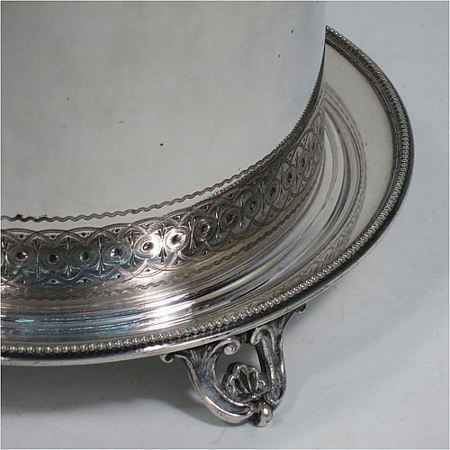 A very pretty Antique Victorian Silver Plated biscuit box, having a round body with straight sides and applied bead-edged borders, with very pretty hand-engraved bands of geometrical and floral work, a hinged flat lid with bone finial, and all sitting on an attached plate with four cast scroll and shell feet. Made by Elkington and Co., of Sheffield in ca. 1880. The dimensions of this fine hand-made antique silver-plated biscuit box are height 16 cms (6.3 inches), and diameter at base 18 cms (7 inches).    