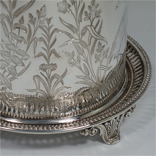 An Antique Victorian Silver Plated Chinoiserie style biscuit box, having a round body with straight sides and applied bead-edged borders, with very pretty hand-engraved flowers, reeds, birds, and butterfly work, a hinged domed lid with cast finial, and all sitting on a hand-pierced attached plate with four cast scroll feet. Made by the Atkin Brothers of Sheffield in ca. 1880. The dimensions of this fine hand-made antique silver-plated biscuit box are height 18 cms (7 inches), and diameter at base 17.5 cms (7 inches).    