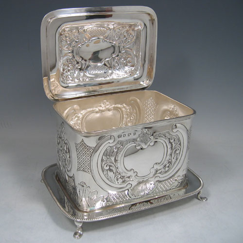 Sterling silver large hand-chased biscuit box with attached plate, made by William Hutton of Sheffield in 1930. Height 18 cms, width 21.5 cms, depth 16 cms. Weight 35 troy ounces.