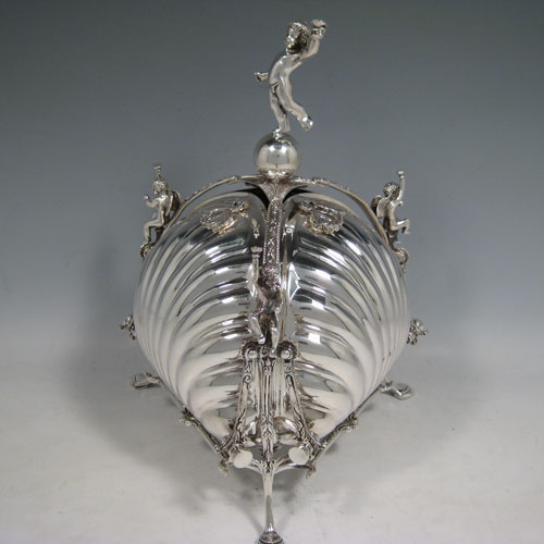 Antique Victorian triple folding biscuit box, having a shell body sitting in a cast foilate frame, with cast seraphims and cherubs, together with a gold-gilt and pierced interior that folds out. Made by Mappin and Webb in ca. 1880. Height 27 cms (10.5 inches), width unfolded 22 cms (8.5 inches), width folded out 32 cms 912.5 inches).   