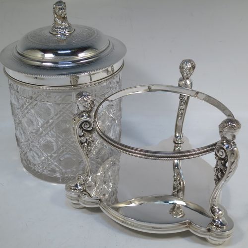 A very pretty Antique Victorian silver-plated and hand-cut crystal biscuit jar, having a hobnail and star cut body, a hinged lid with hand-engraved floral work and a cast leopards head finial, all sitting inside a galleried base with three cast caryatid figures attached to a central band and sitting on three cushion feet, all with bead-edge borders. Made by Henry Atkins of Sheffield in ca. 1880. The dimensions of this fine hand-made silver plated and crystal biscuit box are height 21.5 cms (8.5 inches), and diameter of base 15 cms (6 inches).  