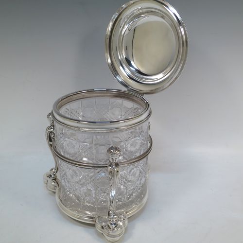 A very pretty Antique Victorian silver-plated and hand-cut crystal biscuit jar, having a hobnail and star cut body, a hinged lid with hand-engraved floral work and a cast leopards head finial, all sitting inside a galleried base with three cast caryatid figures attached to a central band and sitting on three cushion feet, all with bead-edge borders. Made by Henry Atkins of Sheffield in ca. 1880. The dimensions of this fine hand-made silver plated and crystal biscuit box are height 21.5 cms (8.5 inches), and diameter of base 15 cms (6 inches).  