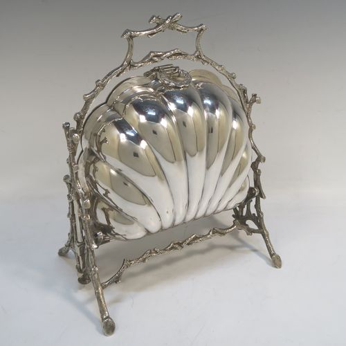 A beautiful Antique Victorian Silver Plated double folding biscuit box, having a plain shell-style body sitting in a cast tree branch designed frame, with a gold-gilt interior and original hand-pierced dividers. This very pretty antique plated biscuit box was made by James Dixon and Sons of Sheffield in ca. 1880. The dimensions of this fine hand-made antique silver-plated folding biscuit box are height 26 cms (10.25 inches), length fully opened 32 cms (12.5 inches), and width 20 cms (8 inches).   