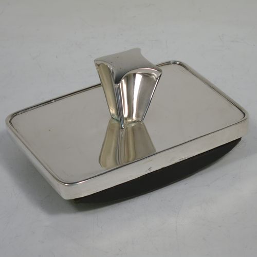 A very handsome Antique Victorian Sterling Silver Rocker Blotter, having a plain rectangular body with rounded corners, a wooden green felt covered rocker base, and an unusual scalloped handle that screws in to secure the rocker base and blotting paper to the upper body. Made by Daniel and Arter of Birmingham in 1901. The dimensions of this fine hand-made antique silver rocker blotter are length 11 cms (4.3 inches), height 6 cms (2.3 inches), and width 7.5 cms (3 inches).    