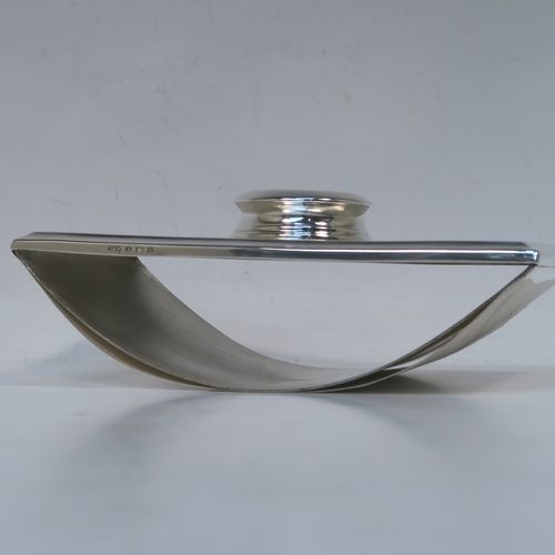 A handsome and unusual Sterling Silver Rocker Blotter, having a rectangular body with engine-turned decoration and plain chamfered borders, a plain round central handle, and a sprung steel plate held under tension that holds the blotting paper to the upper body. This beautiful silver rocker blotter was made by Turner and Simpson of Birmingham in 1956. The dimensions of this fine hand-made silver rocker blotter are length 15 cms (6 inches), height 5 cms (2 inches), width 8.5 cms (3.25 inches), and it weighs approx. 150g (4.8 ozt).   