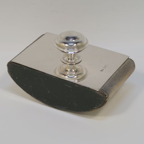 A handsome Antique Sterling Silver Rocker Blotter, having a very plain rectangular body, a solid wooden  rocker base, and a plain round domed handle that screws in to secure the rocker base and blotting paper to the upper body. This elegant silver rocker blotter was made by George Unite of Birmingham in 1915. The dimensions of this fine hand-made antique silver rocker blotter are length 11 cms (4.3 inches), height 7 cms (2.75 inches), and width 7 cms (2.75 inches).  