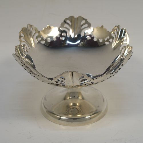 A pretty pair of Sterling Silver bon-bon dishes, having round bodies, with hand-pierced and wavey edge top borders, and sitting on plain round pedestal feet. These elegant silver bon-bon dishes were made by Emile Viner of Sheffield in 1958. The dimensions of these fine hand-made silver bon-bon dishes are height 7 cms (2.75 inches), diameter 11 cms (4.3 inches), and they weigh a total of approx. 212g (6.8 troy ounces).   