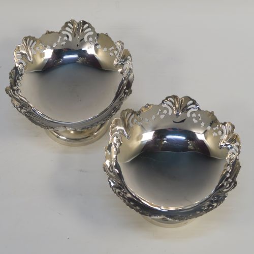 A pretty pair of Sterling Silver bon-bon dishes, having round bodies, with hand-pierced and wavey edge top borders, and sitting on plain round pedestal feet. These elegant silver bon-bon dishes were made by Emile Viner of Sheffield in 1958. The dimensions of these fine hand-made silver bon-bon dishes are height 7 cms (2.75 inches), diameter 11 cms (4.3 inches), and they weigh a total of approx. 212g (6.8 troy ounces).   