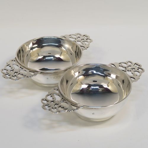 A very handsome Sterling Silver pair of bon-bon dishes, in a Quaich style having plain round bellied bodies, with hand-pierced side-handles, and all sitting on round collet feet. This elegant pair of silver bon-bon dishes were made by Wakely and Wheeler of London in 1996/7. The dimensions of this fine hand-made pair of silver bon-bon dishes are length (inc. handles) 14.5 cms (5.75 inches), diameter 8.5 cms (3.3 inches), height 4 cms (1.5 inches), and they weigh a total of approx. 215g (6.9 troy ounces).   