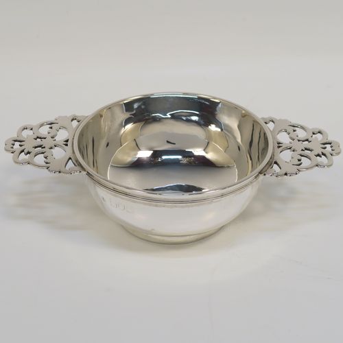 A very handsome Sterling Silver pair of bon-bon dishes, in a Quaich style having plain round bellied bodies, with hand-pierced side-handles, and all sitting on round collet feet. This elegant pair of silver bon-bon dishes were made by Wakely and Wheeler of London in 1996/7. The dimensions of this fine hand-made pair of silver bon-bon dishes are length (inc. handles) 14.5 cms (5.75 inches), diameter 8.5 cms (3.3 inches), height 4 cms (1.5 inches), and they weigh a total of approx. 215g (6.9 troy ounces).   