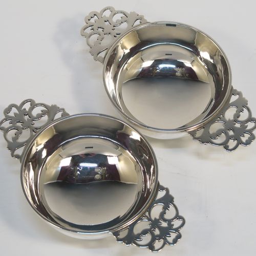 A very handsome Sterling Silver pair of bon-bon dishes, in a Quaich style having plain round bellied bodies, with hand-pierced side-handles, and all sitting on round collet feet. This elegant pair of silver bon-bon dishes were made by Wakely and Wheeler of London in 1996/7. The dimensions of this fine hand-made pair of silver bon-bon dishes are length (inc. handles) 14.5 cms (5.75 inches), diameter 8.5 cms (3.3 inches), height 4 cms (1.5 inches), and they weigh a total of approx. 215g (6.9 troy ounces).   