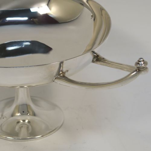 A very elegant Antique Edwardian Sterling Silver bon-bon dish, in an Arts and Crafts style having a plain round body, with two Aladdin lamp style side-handles, and siting on a on a plain round pedestal foot. This handsome silver bon-bon dish was made by Joseph Hemming of London in 1902. The dimensions of this fine hand-made antique silver bon-bon dish are height 9 cms (3.5 inches), diameter 11.5 cms (4.5 inches), and they weigh a total of approx. 210g (6.8 troy ounces).   