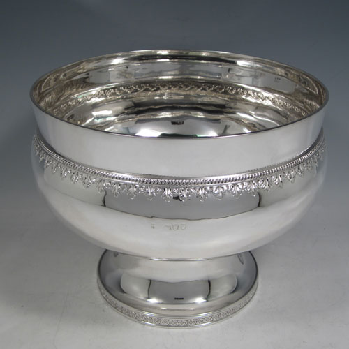 Antique Victorian sterling silver large table bowl, having a round plain baluster body, with a band of hand-chased anthemion leaves below a gadroon rope-twist border, sitting on a pedestal foot with matching decoration. Made by Charles Stuart Harris of London in 1893. The dimensions of this fine hand-made silver bowl are diameter at lip 23 cms (9 inches), height 18.5 cms (7.25 inches), and it weighs approx. 1,141g (36.8 troy ounces).