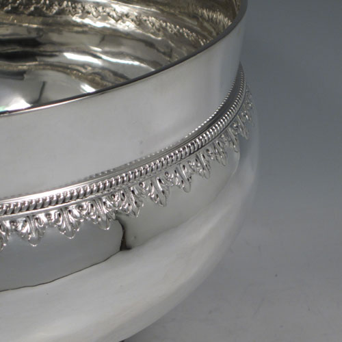 Antique Victorian sterling silver large table bowl, having a round plain baluster body, with a band of hand-chased anthemion leaves below a gadroon rope-twist border, sitting on a pedestal foot with matching decoration. Made by Charles Stuart Harris of London in 1893. The dimensions of this fine hand-made silver bowl are diameter at lip 23 cms (9 inches), height 18.5 cms (7.25 inches), and it weighs approx. 1,141g (36.8 troy ounces).