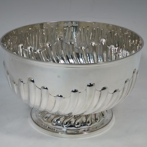 A very nice quality Antique Victorian Sterling Silver Rose bowl, having a round body with hand-chased half swirl-fluted decoration, an applied reeded rim, and sitting on a pedestal foot with matching fluting. Made by John Frank Hall of London in 1895. The dimensions of this fine hand-made antique silver rose bowl are diameter 26 cms (10.25 inches), height 16 cms (6.25 inches), and it weighs approx. 945g (30 troy ounces).    