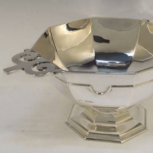 A very handsome Antique Sterling Silver large table bowl, having a plain octagonal panelled body with an applied reeded upper band, together with cast hand-pierced flat scroll handles, and all sitting on a matching pedestal foot. This handsome antique silver bowl was made by Johnson, Walker, and Tolhurst of Sheffield in 1919. The dimensions of this fine hand-made large silver table bowl are diameter 24 cms (9.5 inches), height 15 cms (6 inches), and it weighs approx. 1,269g (41 troy ounces).   