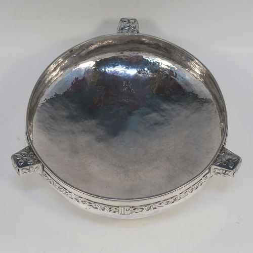 A very unusual and beautiful Antique Sterling Silver Art and Crafts style table bowl, having a round bellied body with hand-hammered decoration, an applied rope-twist top border, together with an applied central band of leaf design work, with three matching side-handles, and all sitting on a pedestal foot. This superb Arts and Crafts style  silver table bowl was made by John Sydney Reeve of  Birmingham in 1912. The dimensions of this fine hand-made antique silver bowl are height 8.5 cms (3.3 inches), diameter at top of bowl 24 cms (9.5 inches), and it weighs approx. 799g (25.8 troy ounces).   