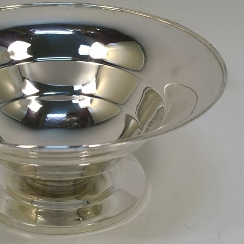 A very handsome Art Deco style Sterling Silver table bowl, having a plain round body with tapering sides and hand-chased bands of reeding, and sitting on a matching pedestal foot. This elegant silver bowl bowl was made by James Gloster Ltd., of Birmingham in 1943. The dimensions of this fine hand-made silver Art Deco bowl are diameter 20 cms (8 inches), height 9 cms (3.5 inches), and it weighs approx. 290g (9.4 troy ounces).   