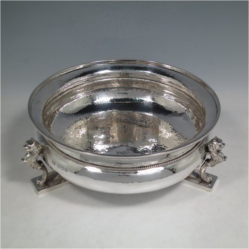 A Sterling Silver Arts & Crafts rose bowl, having a round hand-hammered baluster body with applied rope-twist borders, and sitting on three cast scroll leopards feet. Made by Charles Boyton of London in 1937. The dimensions of this fine hand-made silver bowl are height 9 cms (3.5 inches), diameter 23 cms (9 inches), and it weighs approx. 1,006g (32 troy ounces).    