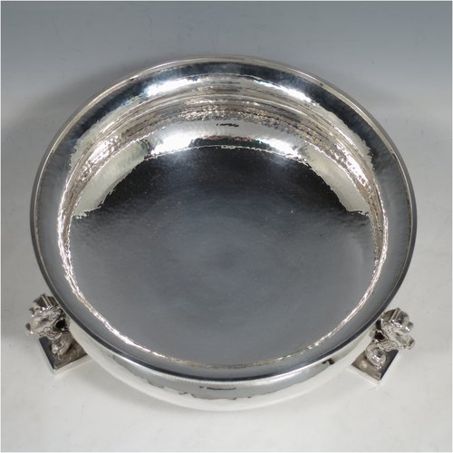 A Sterling Silver Arts & Crafts rose bowl, having a round hand-hammered baluster body with applied rope-twist borders, and sitting on three cast scroll leopards feet. Made by Charles Boyton of London in 1937. The dimensions of this fine hand-made silver bowl are height 9 cms (3.5 inches), diameter 23 cms (9 inches), and it weighs approx. 1,006g (32 troy ounces).    