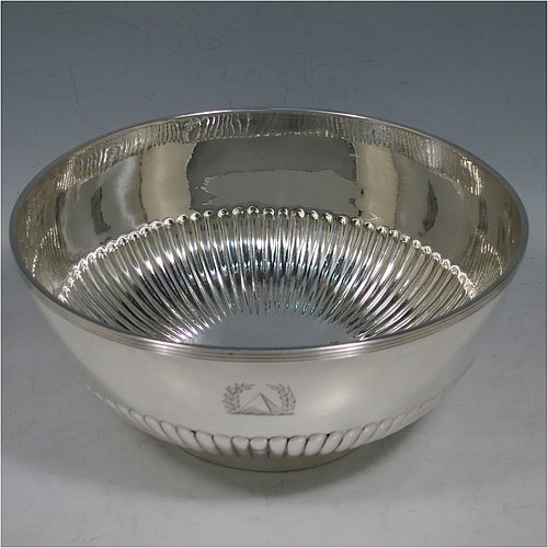 A rare Antique Georgian Sterling Silver Rose bowl, having a round body with hand-chased half-fluted decoration, an applied reeded border, and sitting on a collet foot. Made by John Robins of London in 1801. The dimensions of this fine hand-made silver bowl are height 8 cms (3.25 inches), diameter 18 cms (7 inches), and it weighs approx. 452g (14.6 troy ounces). Please note that this item is crested.    