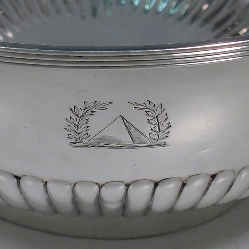 A rare Antique Georgian Sterling Silver Rose bowl, having a round body with hand-chased half-fluted decoration, an applied reeded border, and sitting on a collet foot. Made by John Robins of London in 1801. The dimensions of this fine hand-made silver bowl are height 8 cms (3.25 inches), diameter 18 cms (7 inches), and it weighs approx. 452g (14.6 troy ounces). Please note that this item is crested.    