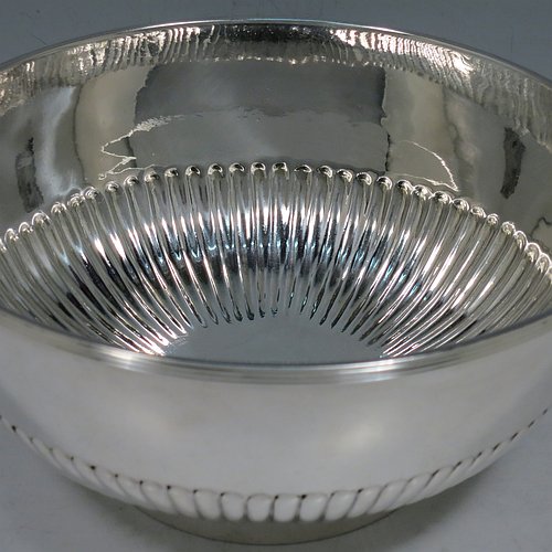 A rare Antique Georgian Sterling Silver Rose bowl, having a round body with hand-chased half-fluted decoration, an applied reeded border, and sitting on a collet foot. Made by John Robins of London in 1801. The dimensions of this fine hand-made silver bowl are height 8 cms (3.25 inches), diameter 18 cms (7 inches), and it weighs approx. 452g (14.6 troy ounces). Please note that this item is crested.    