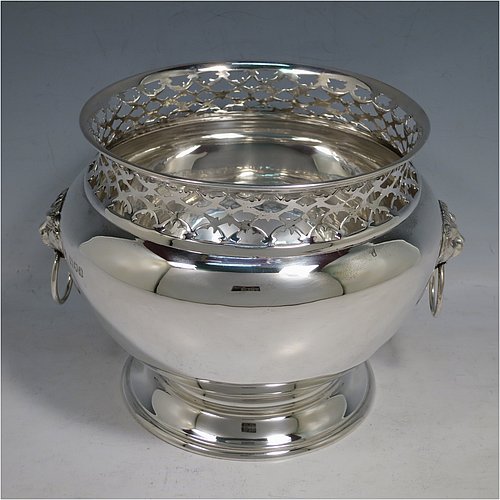 An Antique Victorian Sterling Silver table bowl, having a plain round bellied body with a hand-pierced top gallery border, together with two cast lion-mask and ring side-handles, and sitting on a plain round pedestal foot. Made by Gibson & Langland of London in 1899. The dimensions of this fine hand-made antique silver table bowl are diameter 18 cms (7 inches), height 14 cms (5.5 inches), and it weighs approx. 581g (18.7 troy ounces).    