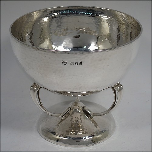 A very pretty Sterling Silver Art Nouveau style table bowl, having a round hand-hammered and bellied body, with three cast scroll and tendril supports attached to a pedestal foot. Made by Goldsmiths and Silversmiths of London in 1919. The dimensions of this fine hand-made Art Nouveau hand-hammered silver bowl are height 13 cms (5 inches), diameter at top of bowl 14.5 cms (5.75 inches), and it weighs approx. 360g (11.6 troy ounces).    