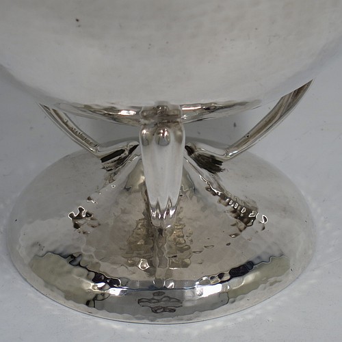 A very pretty Sterling Silver Art Nouveau style table bowl, having a round hand-hammered and bellied body, with three cast scroll and tendril supports attached to a pedestal foot. Made by Goldsmiths and Silversmiths of London in 1919. The dimensions of this fine hand-made Art Nouveau hand-hammered silver bowl are height 13 cms (5 inches), diameter at top of bowl 14.5 cms (5.75 inches), and it weighs approx. 360g (11.6 troy ounces).    