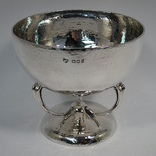 A very pretty Sterling Silver Art Nouveau style table bowl, having a round hand-hammered and bellied body, with three cast scroll and tendril supports attached to a pedestal foot. Made by Goldsmiths and Silversmiths of London in 1919. The dimensions of this fine hand-made Art Nouveau hand-hammered silver bowl are height 13 cms (5 inches), diameter at top of bowl 14.5 cms (5.75 inches), and it weighs approx. 360g (11.6 troy ounces).    