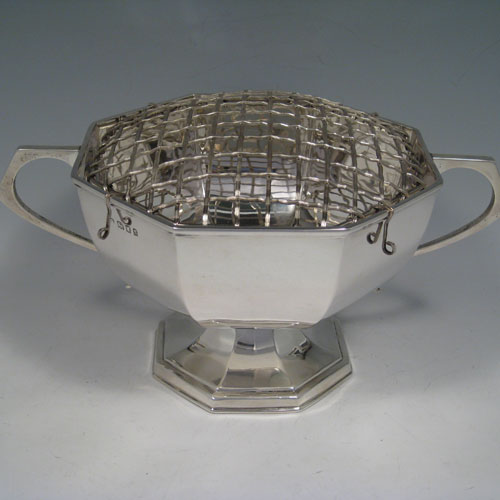 Sterling silver two-handled rose bowl, having a plain octagonal panelled body, two scroll handles, and sitting on a pedestal foot. Made by Kemp Brothers of London in 1922. Height 12.5 cms (5 inches), spread across handles 28 cms (11 inches). Weight approx. 750g (24 troy ounces). Please note that this bowl does NOT come with a rose grill.