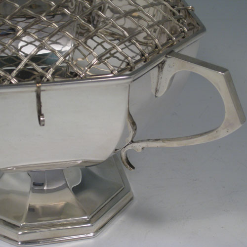 Sterling silver two-handled rose bowl, having a plain octagonal panelled body, two scroll handles, and sitting on a pedestal foot. Made by Kemp Brothers of London in 1922. Height 12.5 cms (5 inches), spread across handles 28 cms (11 inches). Weight approx. 750g (24 troy ounces). Please note that this bowl does NOT come with a rose grill.