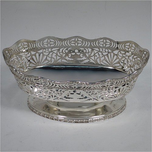 A very pretty pair of Sterling Silver table bowls, having oval bodies with hand-pierced floral and scroll decoration, with applied wavy bead-edged borders, and all sitting on pedestal feet. Made by S. Blanckensee and Sons Ltd., of Chester in 1930. The dimensions of these fine hand-made oval silver bowls are length 19 cms (7.5 inches), width 12.5 cms (5 inches), height 8 cms (3.25 inches), and they weigh a total of approx. 566g (18 troy ounces).   