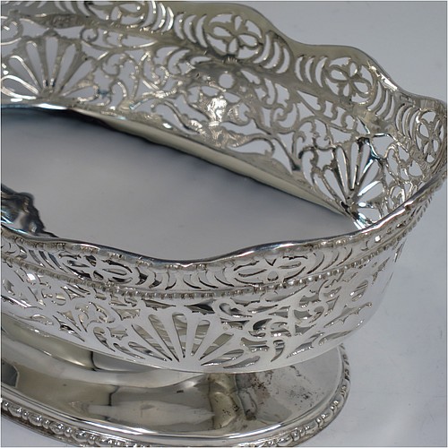 A very pretty pair of Sterling Silver table bowls, having oval bodies with hand-pierced floral and scroll decoration, with applied wavy bead-edged borders, and all sitting on pedestal feet. Made by S. Blanckensee and Sons Ltd., of Chester in 1930. The dimensions of these fine hand-made oval silver bowls are length 19 cms (7.5 inches), width 12.5 cms (5 inches), height 8 cms (3.25 inches), and they weigh a total of approx. 566g (18 troy ounces).   