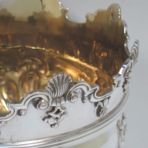 A very pretty Antique Victorian Sterling Silver Montieth style rose bowl, having a round body with hand-chased swirl half-fluting and a gold-gilt interior, below an applied reeded band, an applied shell and scroll border, and all sitting on a pedestal foot. Made by Charles Stuart Harris of London in 1900. The dimensions of this fine hand-made antique silver rose Montieth bowl are height 15 cms (6 inches), diameter 19 cms (7.5 inches), and it weighs approx. 740g (23.9 troy ounces).  