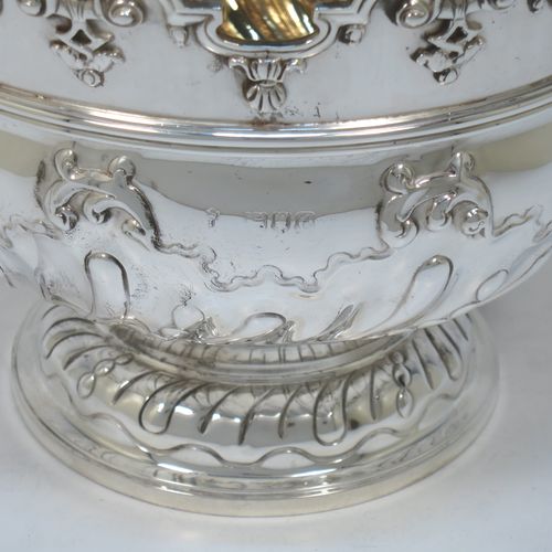 A very pretty Antique Victorian Sterling Silver Montieth style rose bowl, having a round body with hand-chased swirl half-fluting and a gold-gilt interior, below an applied reeded band, an applied shell and scroll border, and all sitting on a pedestal foot. Made by Charles Stuart Harris of London in 1900. The dimensions of this fine hand-made antique silver rose Montieth bowl are height 15 cms (6 inches), diameter 19 cms (7.5 inches), and it weighs approx. 740g (23.9 troy ounces).  