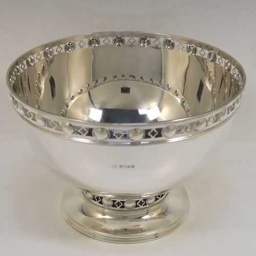 A very handsome Antique Edwardian Sterling Silver Rose bowl, having a plain round body with a pretty hand-pierced top border, and sitting on a round pedestal foot with matching decoration. This elegant antique silver rose bowl was made by Martin Hall and Co., of Sheffield in 1904. The dimensions of this fine hand-made silver bowl are height 14 cms (5.5 inches), diameter 21 cms (8.25 inches), and it weighs approx. 684g (22 troy ounces).