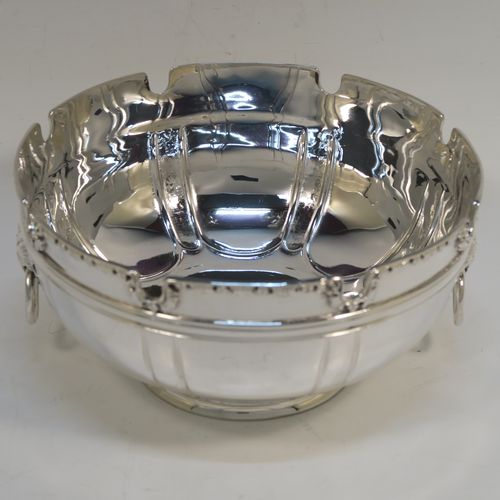 A very elegant Antique Victorian Sterling Silver bowl in a Monteith style, having a round body with hand-chased bands of fluting, an applied cast floral top border, with two cast lions-mask and ring side-handles, and all sitting on a round collet foot. This beautiful antique silver Monteith style bowl was made by Vander and Hedges of London in 1899. The dimensions of this fine hand-made silver bowl are height 8 cms (3.25 inches), diameter 16 cms (6.25 inches), and it weighs arox. 351g (11.3 troy ounces).   