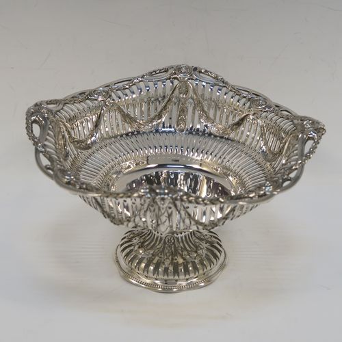 A beautiful Antique Victorian Sterling Silver bowl, having a round body with hand-pierced Neoclassical style decoration, an applied cast floral and swag border, and  sitting on a matching round pedestal foot. This pretty antique silver bowl was made by Frazer and Haws of London in 1899. The dimensions of this fine hand-made antique silver bowl are height 12 cms (4.75 inches), diameter 21 cms (8.25 inches), and it weighs approx. 527g (17 troy ounces).   